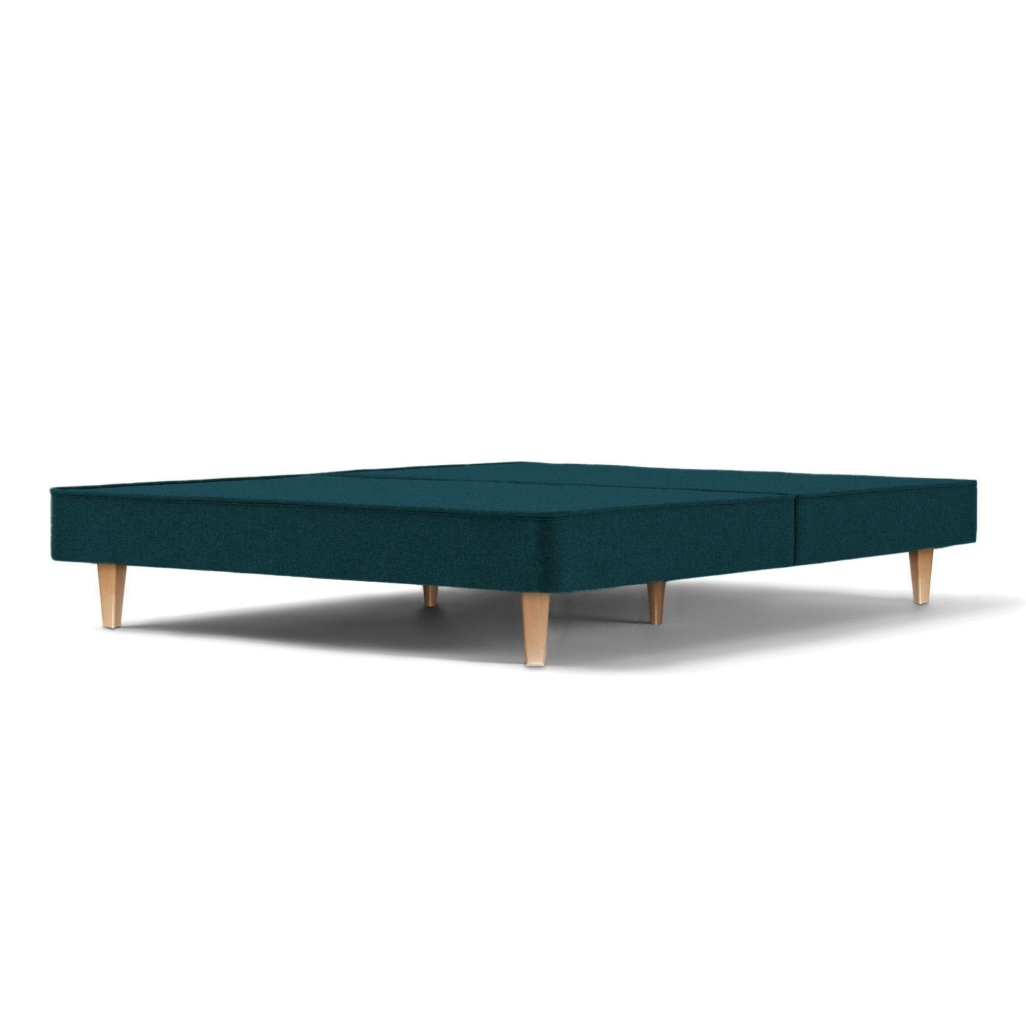 The Woolroom Audley Upholstered Divan with wooden legs in the colour Pine, which is a dark green upholstery.