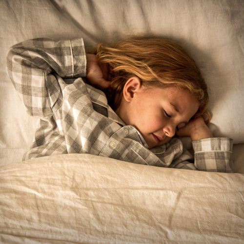 Image of a green Woolroom kids label sewn into the edge of a kids pillow